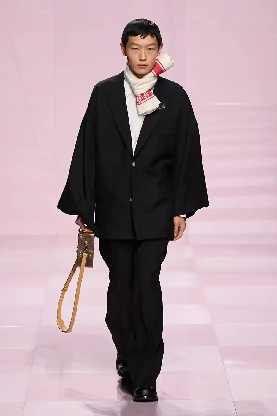 Louis Vuitton Louis Vuitton's Fall/Winter 2025 menswear collection, detailing the creative collaboration between Pharrell Williams and NIGO, featuring streetwear elements, Japanese craftsmanship, and French luxury design, with references to historical brand elements and new patterns. (image 2 of 23)
