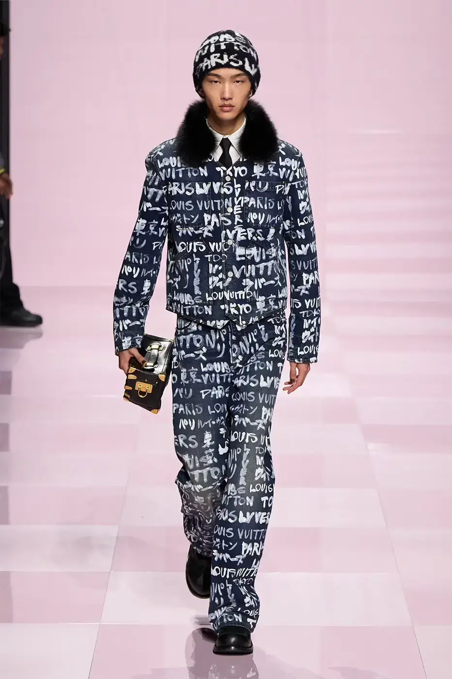 Louis Vuitton Louis Vuitton's Fall/Winter 2025 menswear collection, detailing the creative collaboration between Pharrell Williams and NIGO, featuring streetwear elements, Japanese craftsmanship, and French luxury design, with references to historical brand elements and new patterns. (image 14 of 23)