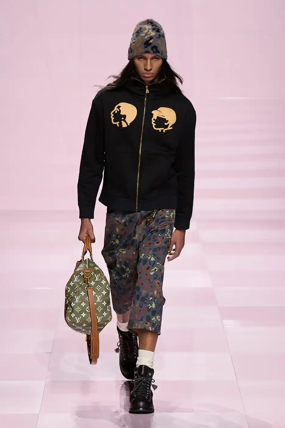 Louis Vuitton Louis Vuitton's Fall/Winter 2025 menswear collection, detailing the creative collaboration between Pharrell Williams and NIGO, featuring streetwear elements, Japanese craftsmanship, and French luxury design, with references to historical brand elements and new patterns. (image 9 of 23)