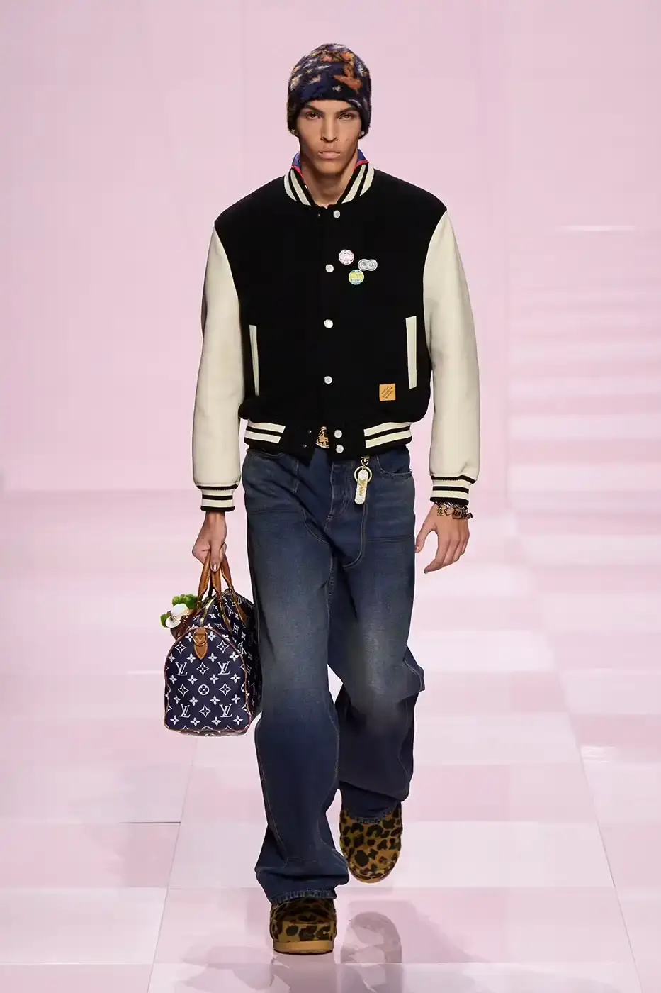 Louis Vuitton Louis Vuitton's Fall/Winter 2025 menswear collection, detailing the creative collaboration between Pharrell Williams and NIGO, featuring streetwear elements, Japanese craftsmanship, and French luxury design, with references to historical brand elements and new patterns. (image 16 of 23)