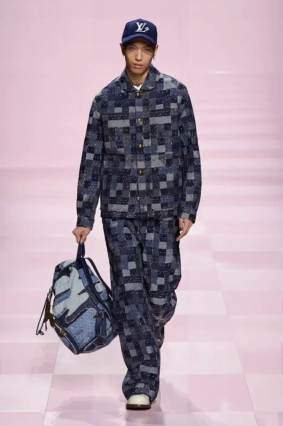 Louis Vuitton Louis Vuitton's Fall/Winter 2025 menswear collection, detailing the creative collaboration between Pharrell Williams and NIGO, featuring streetwear elements, Japanese craftsmanship, and French luxury design, with references to historical brand elements and new patterns. (image 7 of 23)