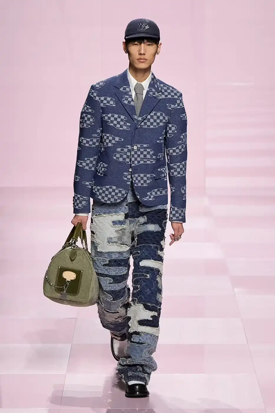 Louis Vuitton Louis Vuitton's Fall/Winter 2025 menswear collection, detailing the creative collaboration between Pharrell Williams and NIGO, featuring streetwear elements, Japanese craftsmanship, and French luxury design, with references to historical brand elements and new patterns. (image 6 of 23)