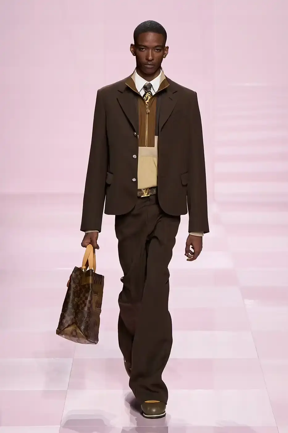 Louis Vuitton Louis Vuitton's Fall/Winter 2025 menswear collection, detailing the creative collaboration between Pharrell Williams and NIGO, featuring streetwear elements, Japanese craftsmanship, and French luxury design, with references to historical brand elements and new patterns. (image 18 of 23)
