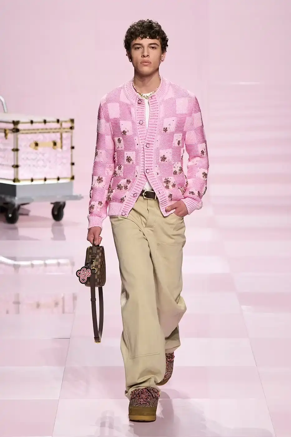 Louis Vuitton Louis Vuitton's Fall/Winter 2025 menswear collection, detailing the creative collaboration between Pharrell Williams and NIGO, featuring streetwear elements, Japanese craftsmanship, and French luxury design, with references to historical brand elements and new patterns. (image 17 of 23)