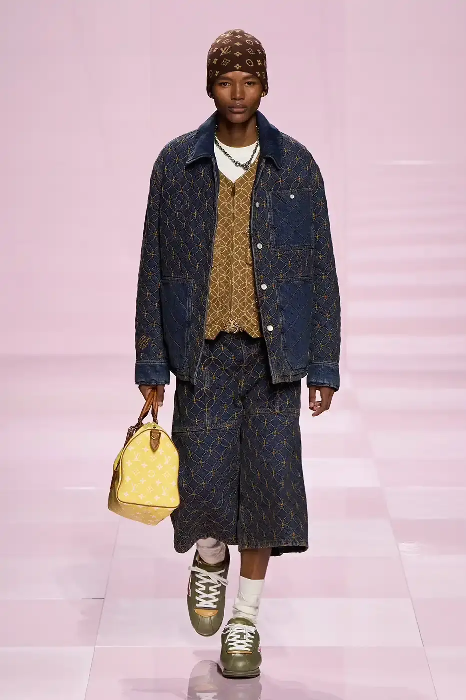 Louis Vuitton Louis Vuitton's Fall/Winter 2025 menswear collection, detailing the creative collaboration between Pharrell Williams and NIGO, featuring streetwear elements, Japanese craftsmanship, and French luxury design, with references to historical brand elements and new patterns. (image 10 of 23)