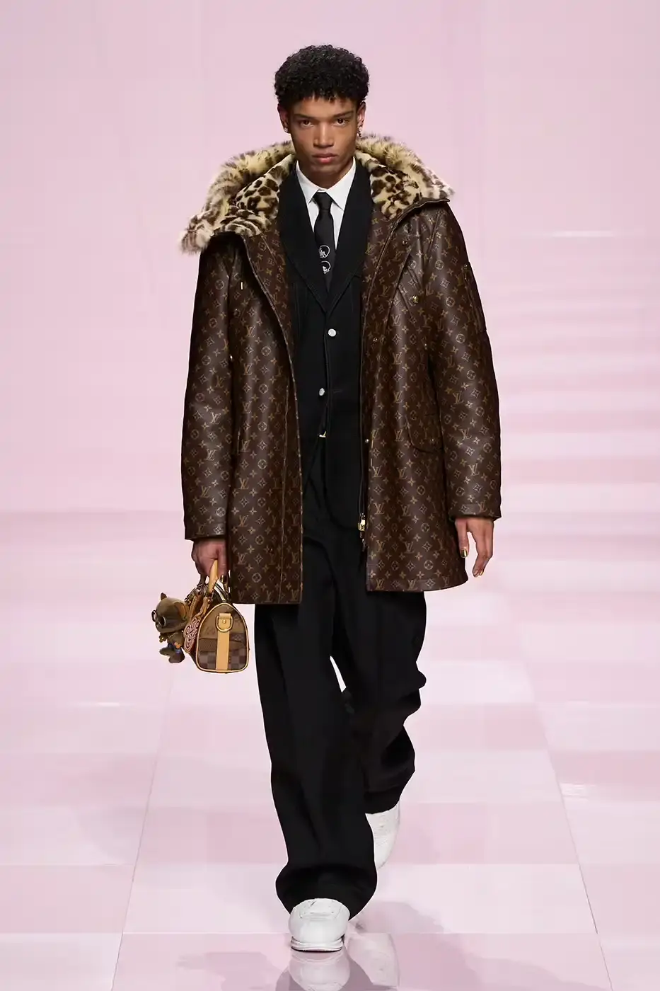 Louis Vuitton Louis Vuitton's Fall/Winter 2025 menswear collection, detailing the creative collaboration between Pharrell Williams and NIGO, featuring streetwear elements, Japanese craftsmanship, and French luxury design, with references to historical brand elements and new patterns. (image 8 of 23)