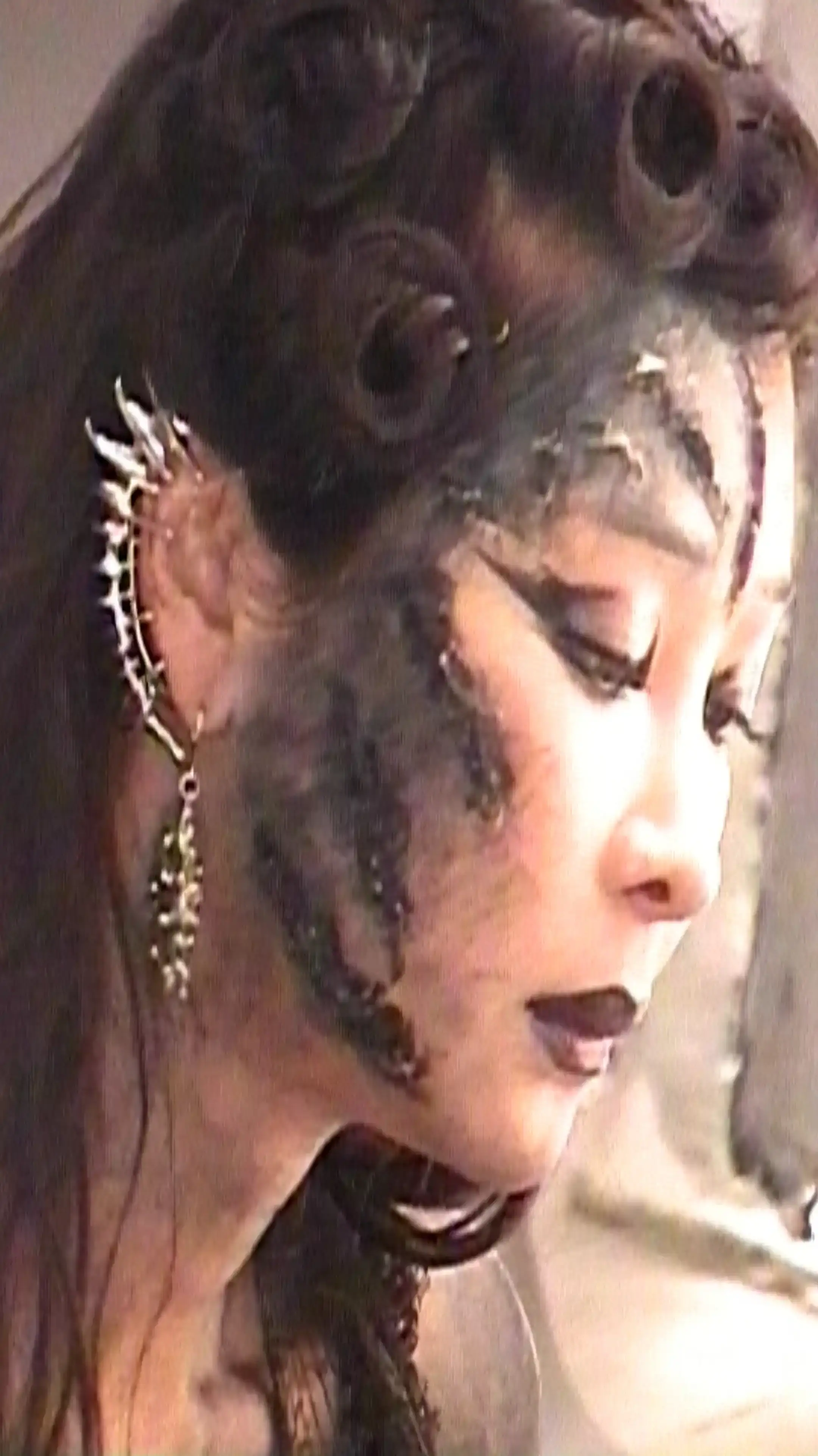 image of fashion designer Luna Manjetsu and her brand Taste of Moon. Manjetsu creates clothing from recycled materials, viewing fashion as personal healing and collective empowerment. Born under a full moon in Taiwan, she draws from experiences with domestic violence to design pieces that celebrate vulnerability and resilience. Her work blends spirituality with sustainability, creating garments she describes as rituals. The interview covers her creative process, use of waste materials, theatrical influences, and vision for authentic fashion outside traditional industry systems. article by Teresa borriello and photography by Arik Amodeo (image 4 of 4)