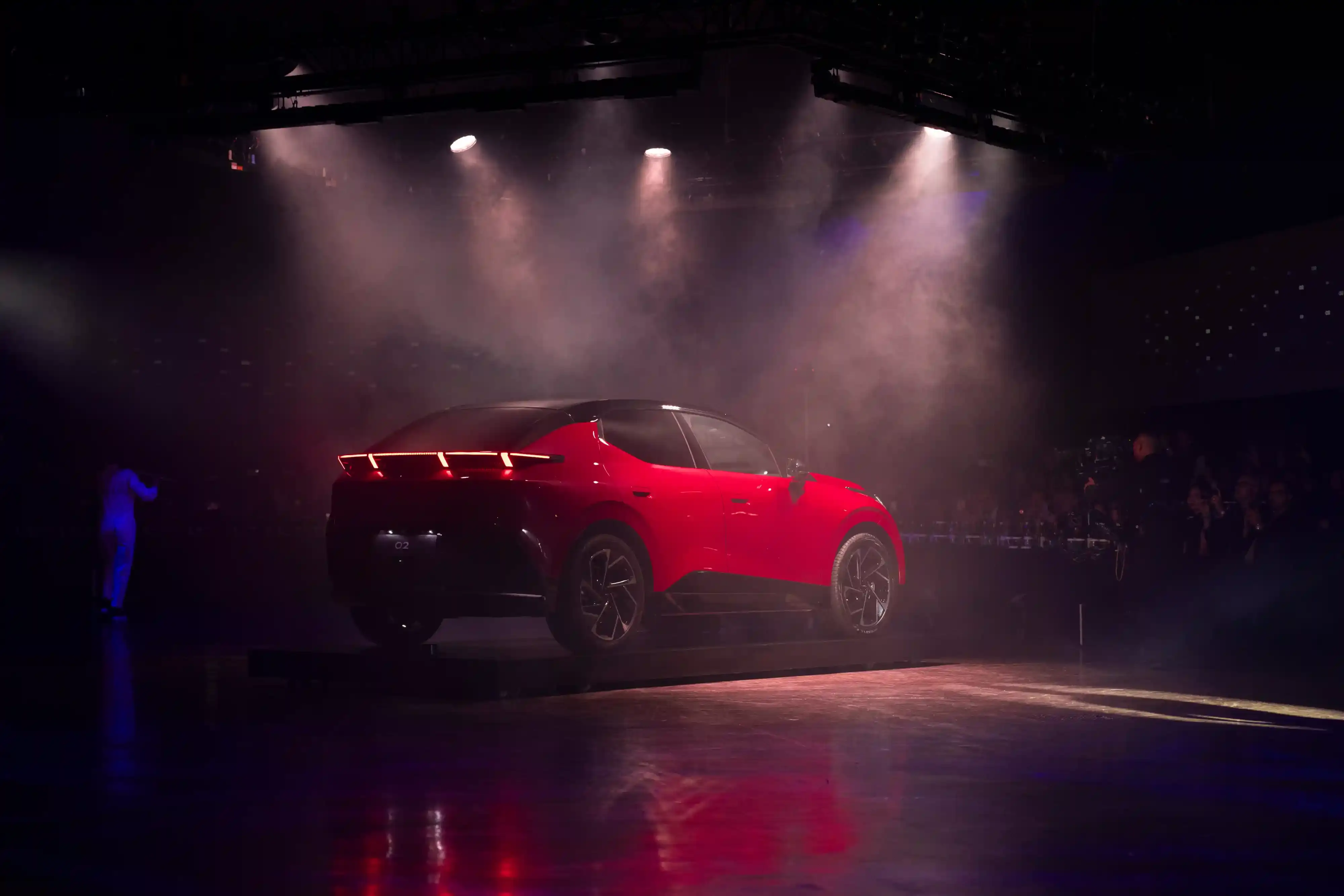 LYNK & CO LAUNCHES 02: FIRST ELECTRIC VEHICLE FOR EUROPEAN MARKET Lynk & Co 02 electric vehicle displayed at Spazio Antologico in Milan, showing the car's front three-quarter view against architectural backdrop (image 3 of 4)