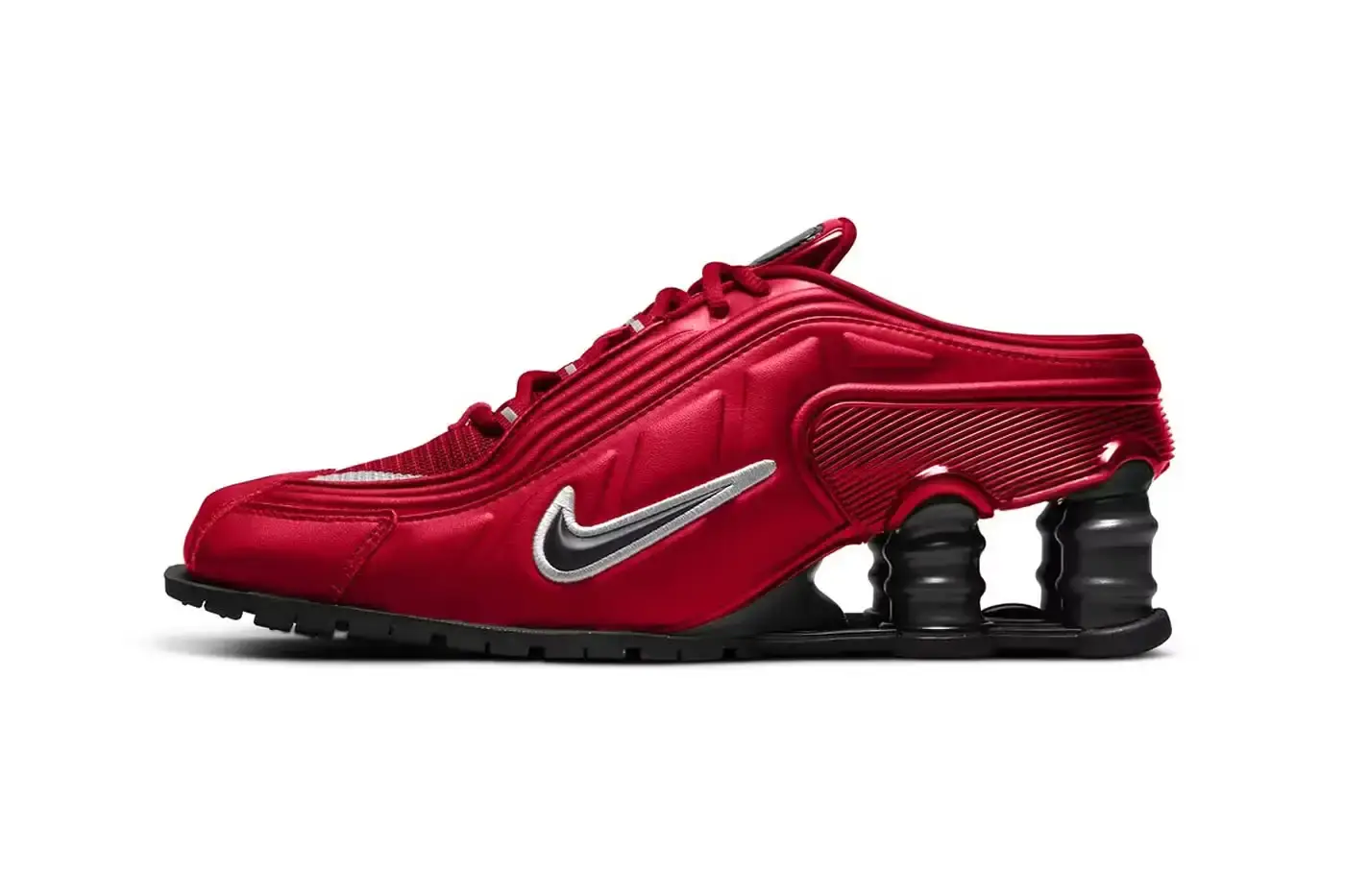 Sneakermarketro The Martine Rose x Nike Shox MR4 sneaker in two colorways. The left shoe shows the Fire Red version with a bright red synthetic leather upper, black accents, and silver Shox columns. The right shoe displays the Metallic Platinum colorway featuring a silver-toned upper with red highlights and white base. Both shoes showcase the distinctive elongated pointed toe and exaggerated heel structure characteristic of the MR4 design.
