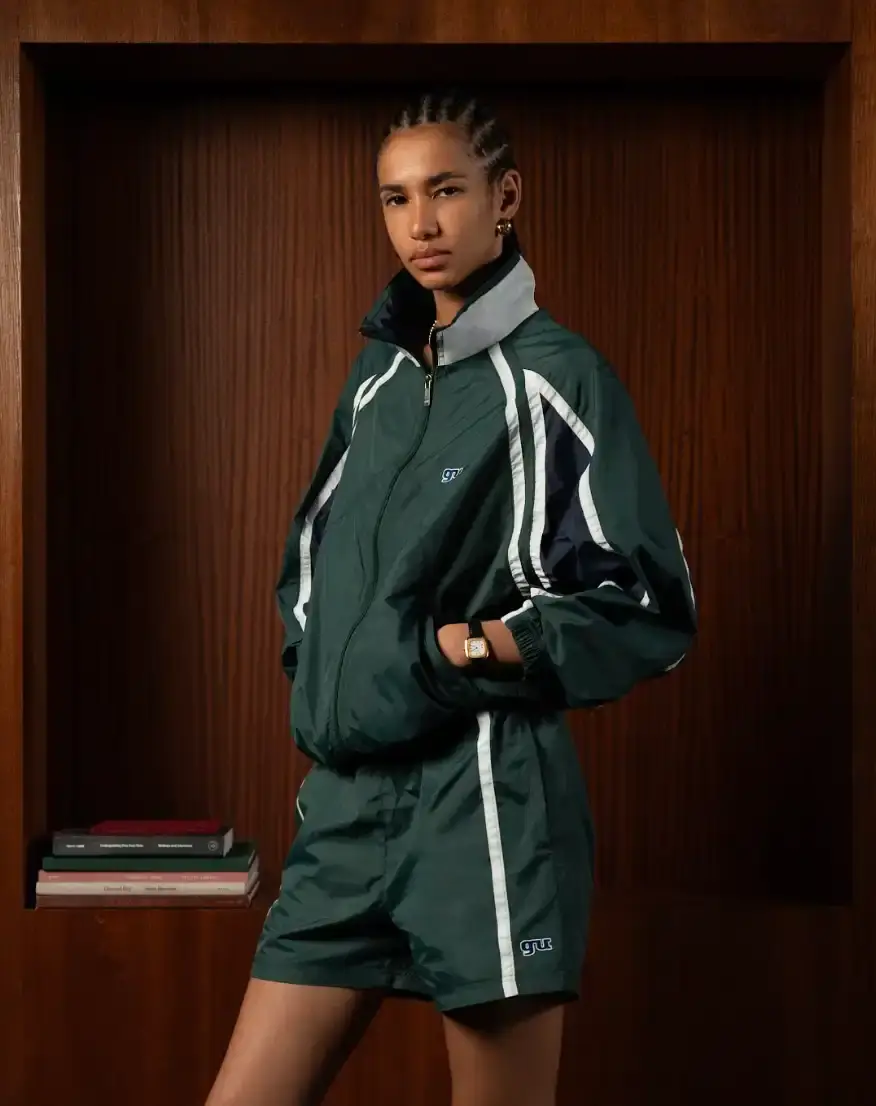 MARYSE SEIGU HONORS OLYMPIC PIONEER IN NEW COLLECTION image about the launch of Maryse Seigu's third fashion collection "CANGUIO S/S 25," which pays tribute to Marlene Canguio, the first woman from Guadeloupe to compete in the Olympic Games. The piece discusses the 13-item athletic-inspired collection that combines Caribbean cultural heritage with contemporary urban fashion, key pieces named after notable Afro-Caribbean athletes, and details about the brand's visual storytelling approach. The article includes information about a launch event in New York on May 23, 2025, and online availability starting May 29, 2025. (image 2 of 6)