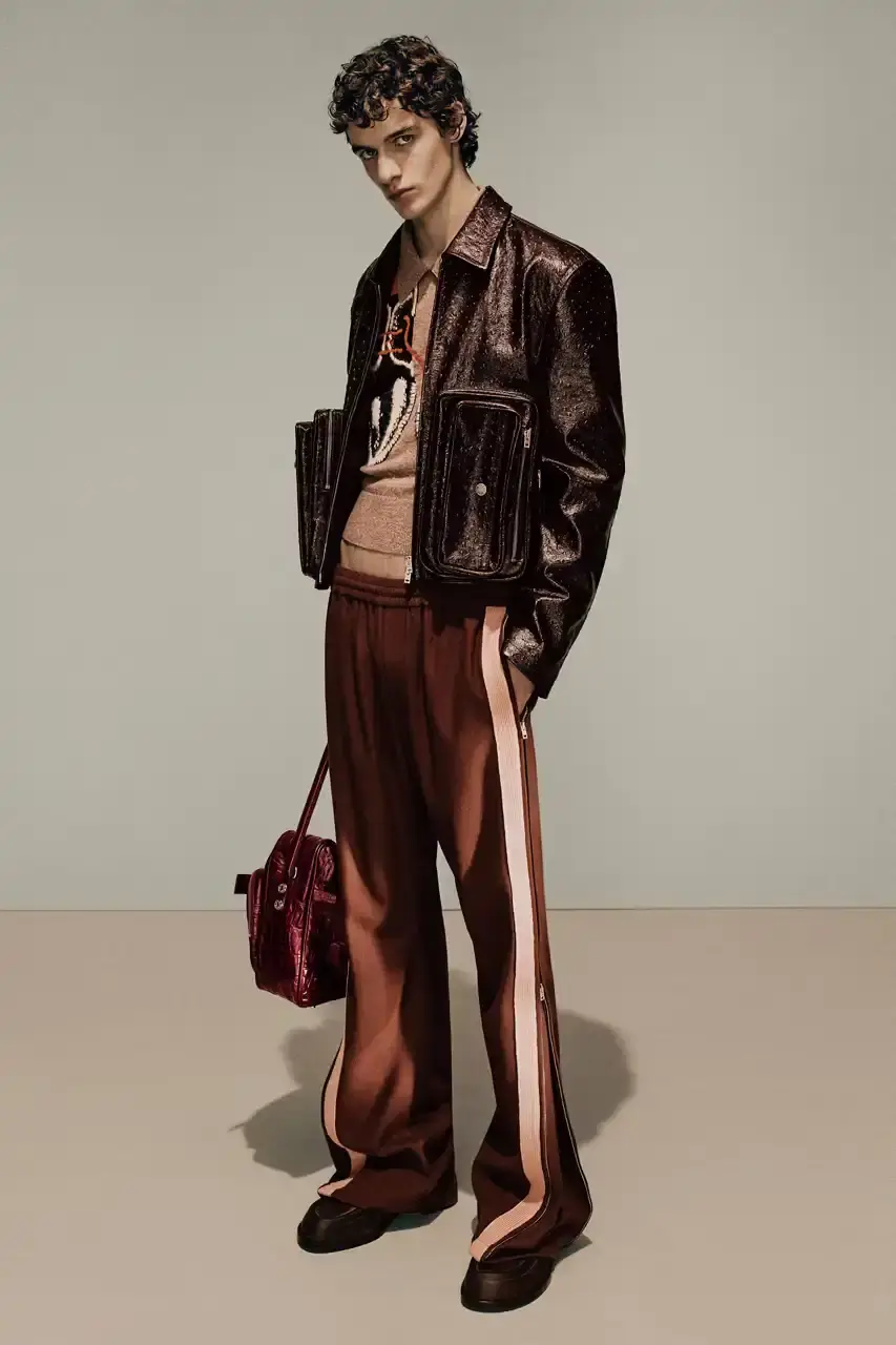 Acne Studios Male model wearing a gray tweed jacket over pink athletic tank top, paired with blue jeans and heart-shaped Acne Studios belt buckle (image 11 of 24)