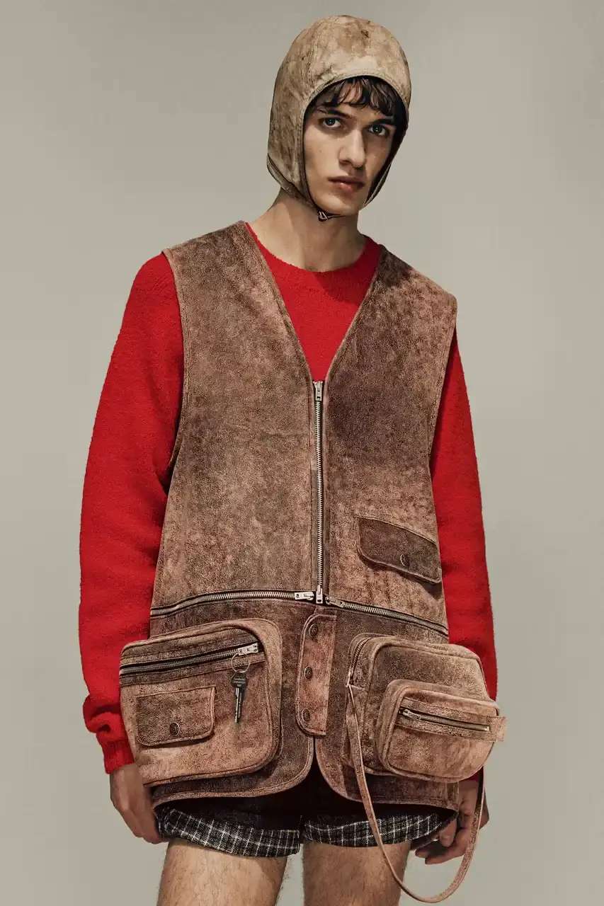 Acne Studios Male model wearing a gray tweed jacket over pink athletic tank top, paired with blue jeans and heart-shaped Acne Studios belt buckle (image 17 of 24)