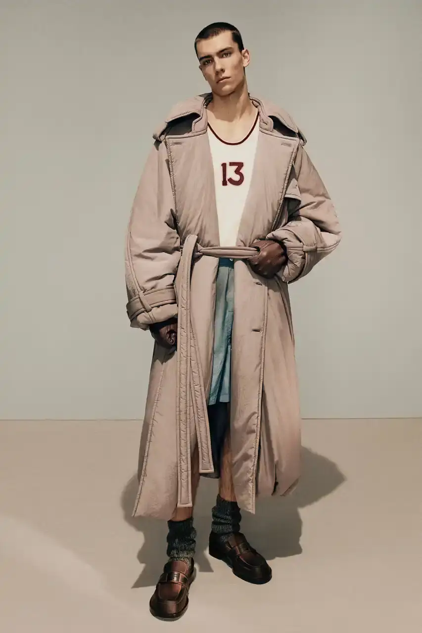 Acne Studios Male model wearing a gray tweed jacket over pink athletic tank top, paired with blue jeans and heart-shaped Acne Studios belt buckle (image 16 of 24)