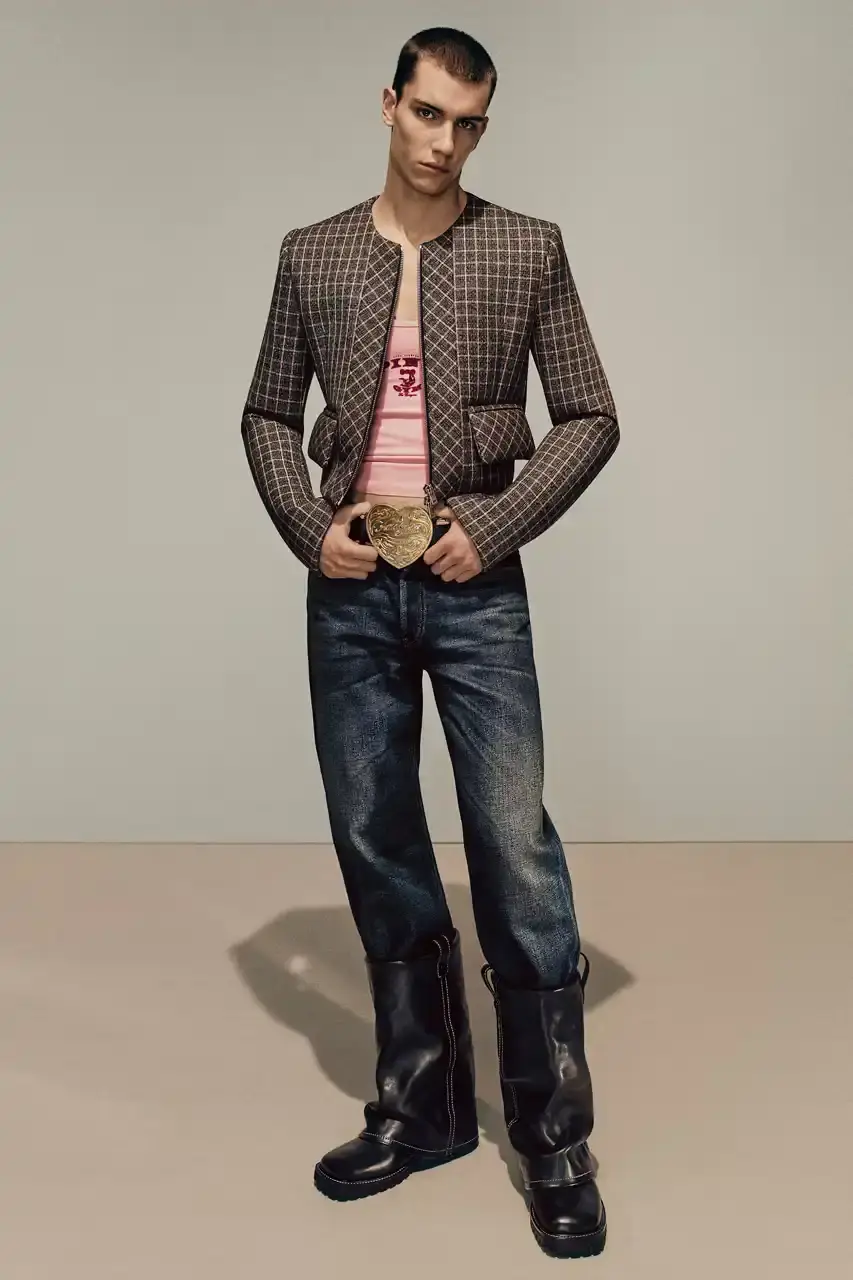 Acne Studios Male model wearing a gray tweed jacket over pink athletic tank top, paired with blue jeans and heart-shaped Acne Studios belt buckle (image 6 of 24)