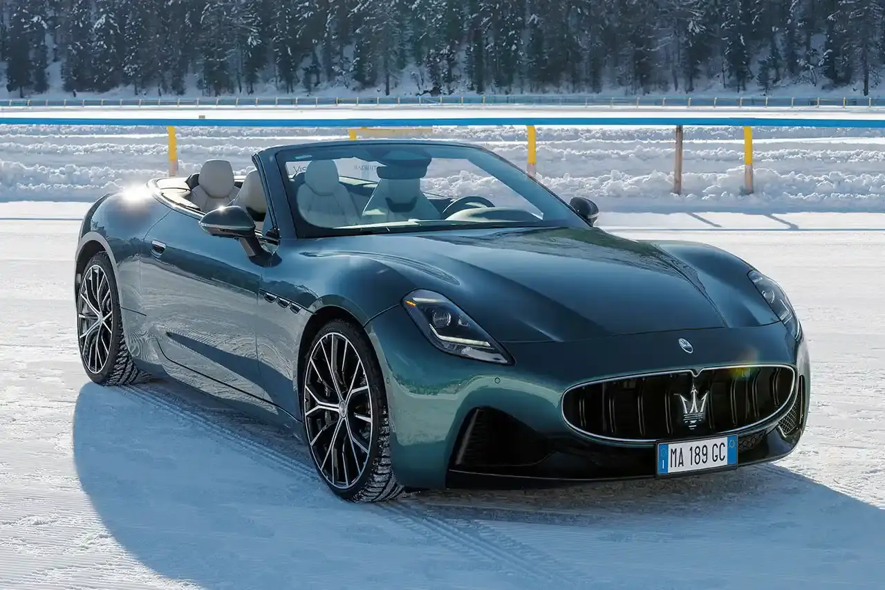 Maserati 2024 Maserati GranCabrio convertible in profile view, parked on snow with Swiss Alps in background at St. Moritz