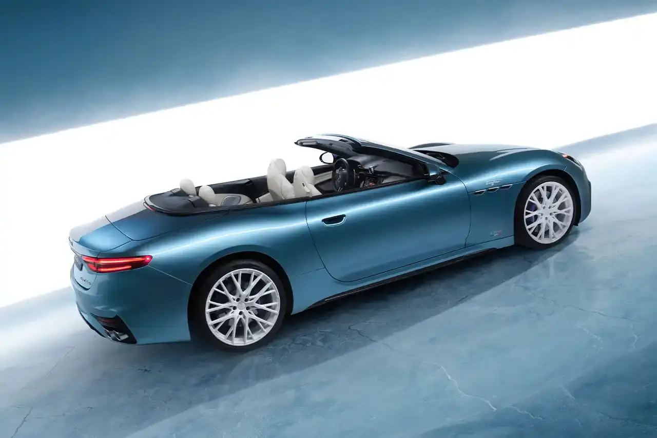 Maserati 2024 Maserati GranCabrio convertible in profile view, parked on snow with Swiss Alps in background at St. Moritz (image 3 of 9)