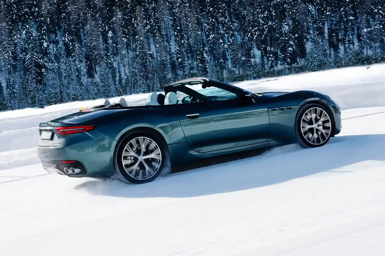 Maserati 2024 Maserati GranCabrio convertible in profile view, parked on snow with Swiss Alps in background at St. Moritz (image 2 of 9)