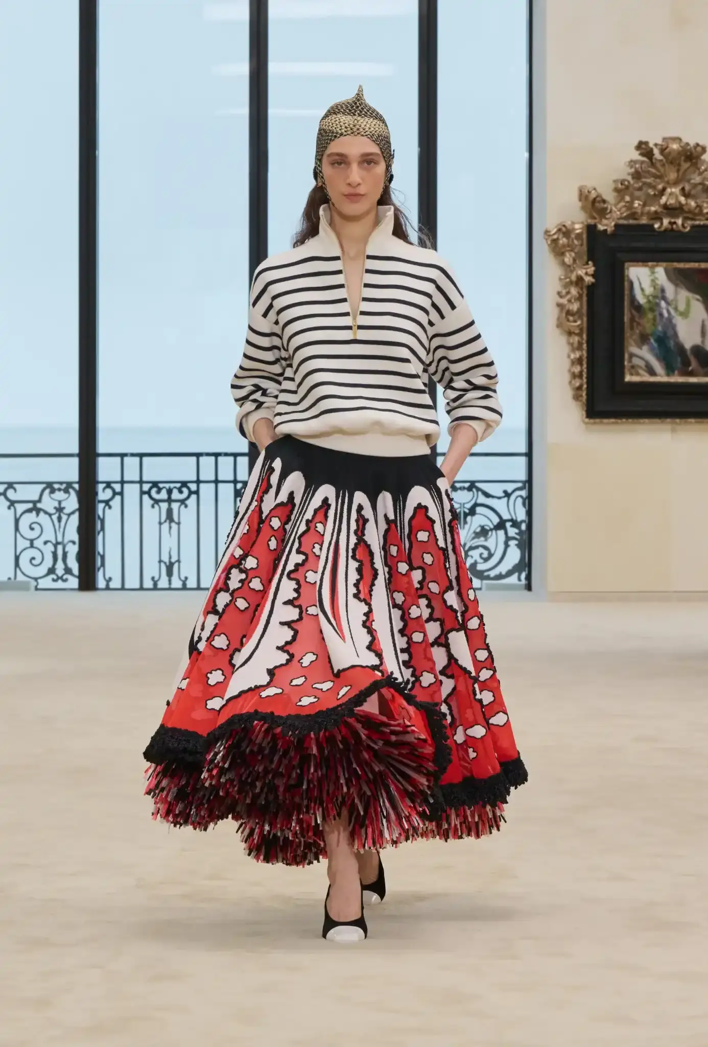 MATTHIEU BLAZY PRESENTS CHANEL CRUISE IN BIARRITZ an image describing the Chanel Cruise collection shown in Biarritz by designer Matthieu Blazy. The article details clothing pieces and front row guests. (image 2 of 10)