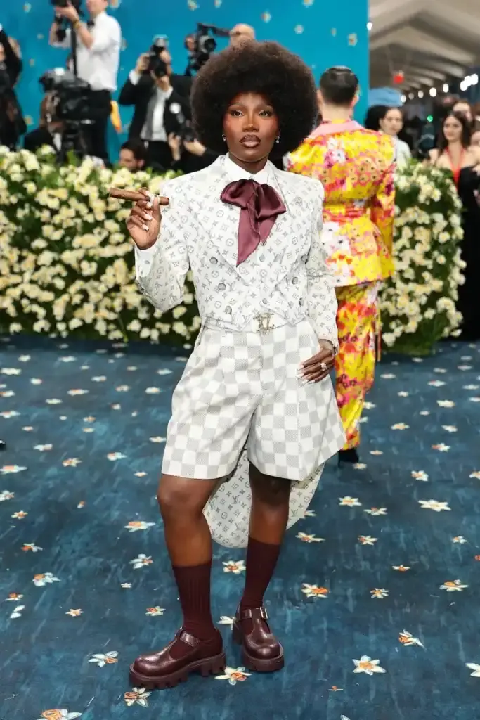 MET GALA 2025: FASHION'S ELITE INTERPRET "TAILORED FOR YOU" image of the 2025 Met Gala event celebrating the "Superfine: Tailoring Black Style" exhibition. It describes key celebrity appearances including André 3000's piano-shouldered look, pregnant Rihanna, and Teyana Taylor's Ruth E. Carter design. The article mentions prominent attendees like A$AP Rocky, Lewis Hamilton, and Zendaya, and highlights Moncler's first-time participation with custom designs for celebrities including Serena Williams and Alicia Keys. The text explains how the event's "Tailored for You" theme connected to Black dandyism and cultural identity expressed through fashion. (image 4 of 10)
