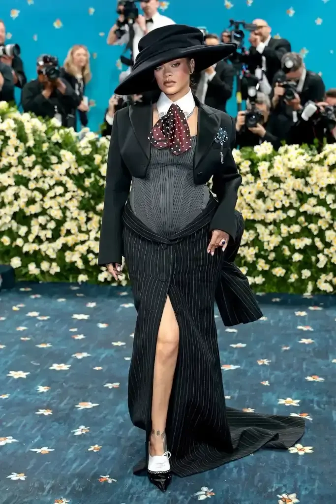 MET GALA 2025: FASHION'S ELITE INTERPRET "TAILORED FOR YOU" image of the 2025 Met Gala event celebrating the "Superfine: Tailoring Black Style" exhibition. It describes key celebrity appearances including André 3000's piano-shouldered look, pregnant Rihanna, and Teyana Taylor's Ruth E. Carter design. The article mentions prominent attendees like A$AP Rocky, Lewis Hamilton, and Zendaya, and highlights Moncler's first-time participation with custom designs for celebrities including Serena Williams and Alicia Keys. The text explains how the event's "Tailored for You" theme connected to Black dandyism and cultural identity expressed through fashion. (image 2 of 10)