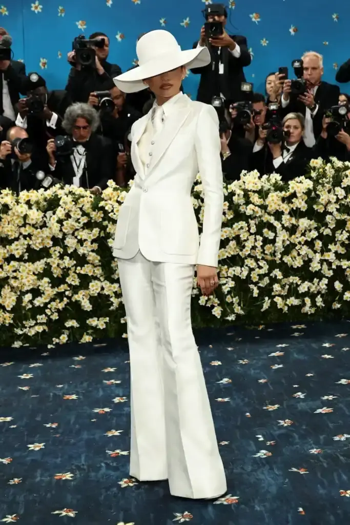MET GALA 2025: FASHION'S ELITE INTERPRET "TAILORED FOR YOU" image of the 2025 Met Gala event celebrating the "Superfine: Tailoring Black Style" exhibition. It describes key celebrity appearances including André 3000's piano-shouldered look, pregnant Rihanna, and Teyana Taylor's Ruth E. Carter design. The article mentions prominent attendees like A$AP Rocky, Lewis Hamilton, and Zendaya, and highlights Moncler's first-time participation with custom designs for celebrities including Serena Williams and Alicia Keys. The text explains how the event's "Tailored for You" theme connected to Black dandyism and cultural identity expressed through fashion. (image 7 of 10)