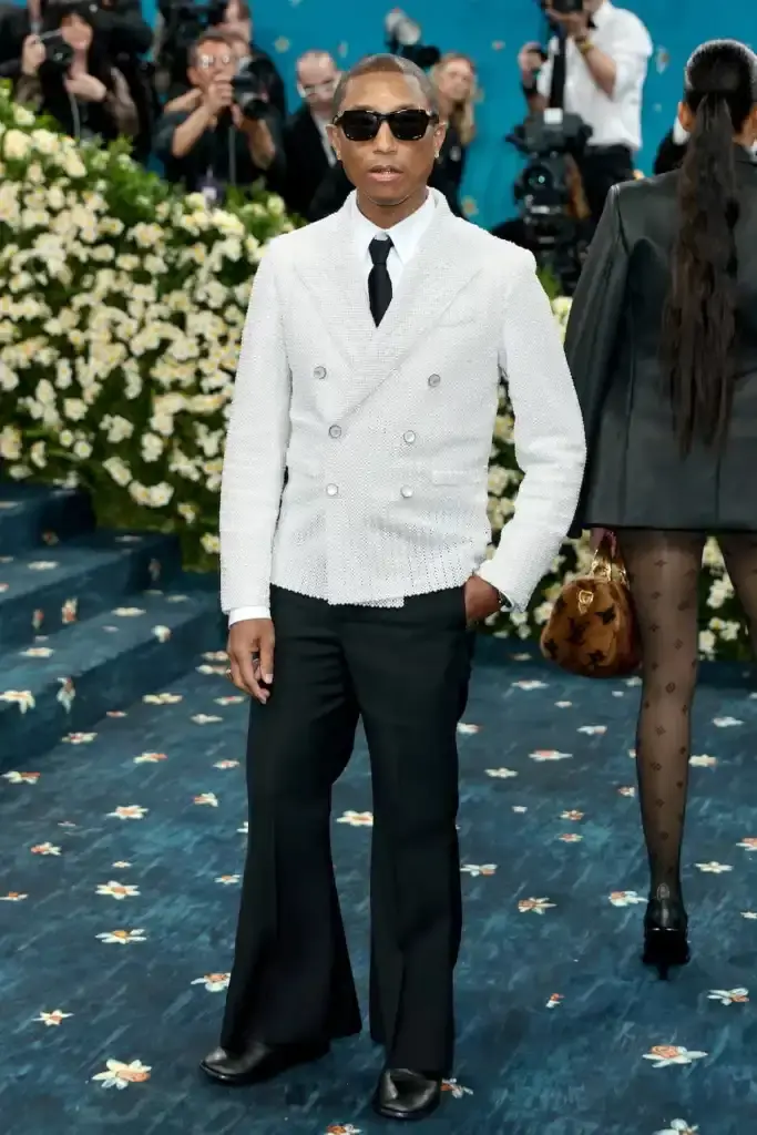 MET GALA 2025: FASHION'S ELITE INTERPRET "TAILORED FOR YOU" image of the 2025 Met Gala event celebrating the "Superfine: Tailoring Black Style" exhibition. It describes key celebrity appearances including André 3000's piano-shouldered look, pregnant Rihanna, and Teyana Taylor's Ruth E. Carter design. The article mentions prominent attendees like A$AP Rocky, Lewis Hamilton, and Zendaya, and highlights Moncler's first-time participation with custom designs for celebrities including Serena Williams and Alicia Keys. The text explains how the event's "Tailored for You" theme connected to Black dandyism and cultural identity expressed through fashion. (image 8 of 10)