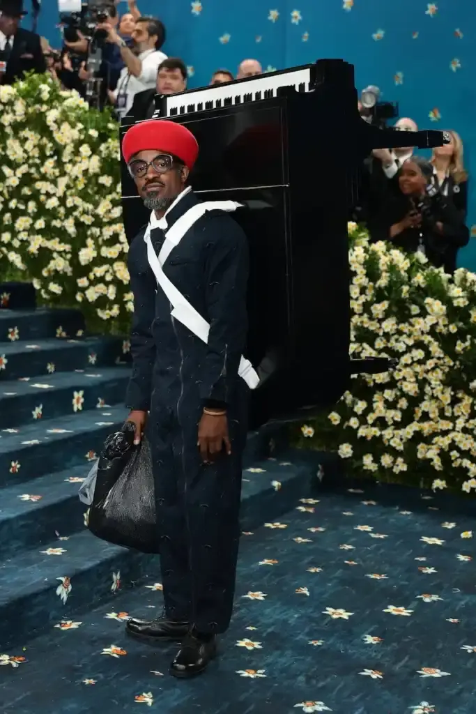 MET GALA 2025: FASHION'S ELITE INTERPRET "TAILORED FOR YOU" image of the 2025 Met Gala event celebrating the "Superfine: Tailoring Black Style" exhibition. It describes key celebrity appearances including André 3000's piano-shouldered look, pregnant Rihanna, and Teyana Taylor's Ruth E. Carter design. The article mentions prominent attendees like A$AP Rocky, Lewis Hamilton, and Zendaya, and highlights Moncler's first-time participation with custom designs for celebrities including Serena Williams and Alicia Keys. The text explains how the event's "Tailored for You" theme connected to Black dandyism and cultural identity expressed through fashion.