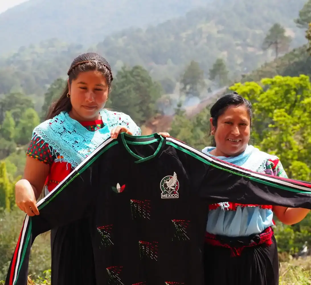 ADIDAS & SOMEONE SOMEWHERE RELEASE MEXICAN FOOTBALL JERSEY This image outlines the release of a limited edition adidas and Someone Somewhere Mexican football jersey. The jersey features hand embroidery by Indigenous artisans. (image 6 of 10)