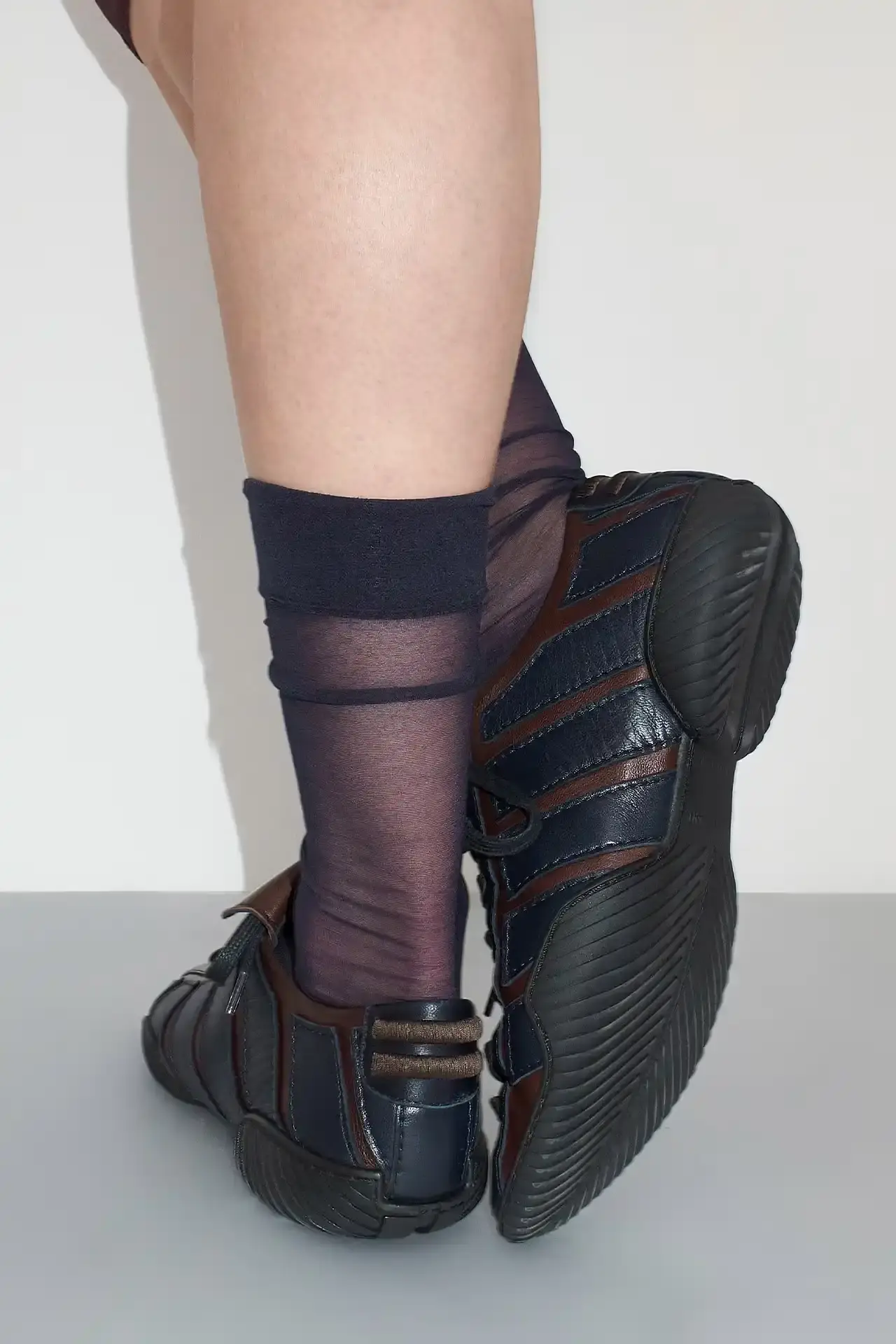 MIISTA'S NIKOLETTA: A THROWBACK TO 80S ATHLETIC FOOTWEAR Photo about Miista's new Nikoletta sneaker. Describes the low-profile design inspired by 1980s athletic footwear, construction details including goat leather and fold-over tongue, available colors (black, brown/navy, black/white), price ($415), and where to purchase. Includes quote from creative director Laura Villasenin about the brand's philosophy of continuous improvement and craftsmanship. (image 4 of 4)