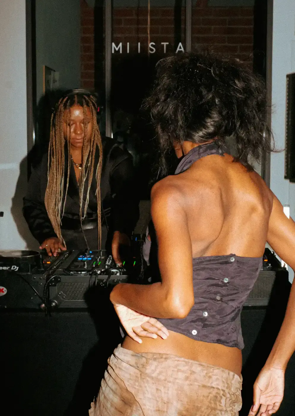 MIISTA SS26 COMBINES TECHNO MUSIC AND GARMENT MENDING An image about on the Miista Spring/Summer 2026 launch in Los Angeles. The text details the music performances and the live garment mending station at The Evans Group factory. (image 9 of 10)