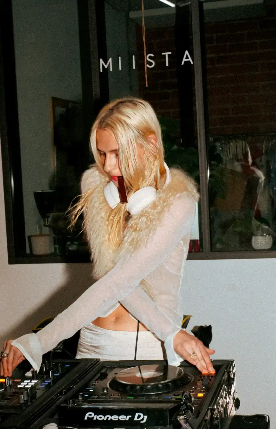 MIISTA SS26 COMBINES TECHNO MUSIC AND GARMENT MENDING An image about on the Miista Spring/Summer 2026 launch in Los Angeles. The text details the music performances and the live garment mending station at The Evans Group factory. (image 5 of 10)