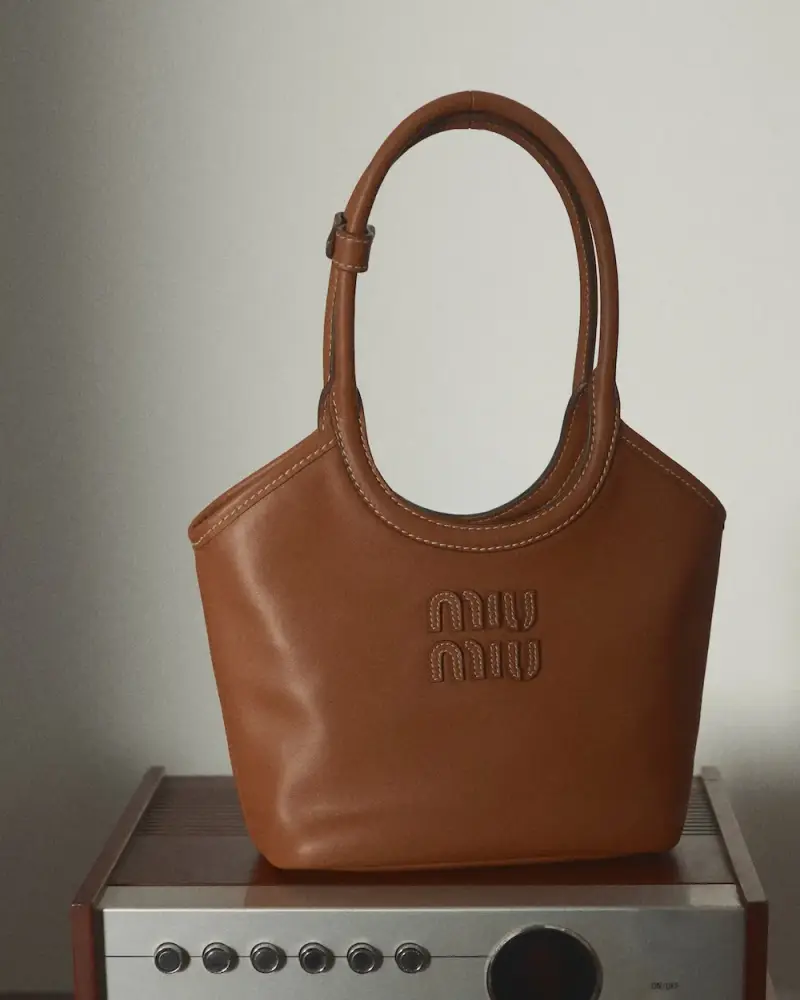 MIU MIU OPENS VINYL CLUB POP-UP SPACES image detailing Miu Miu's Vinyl Club pop-up project, featuring fashion items, custom audio gear, and global location dates. (image 7 of 11)