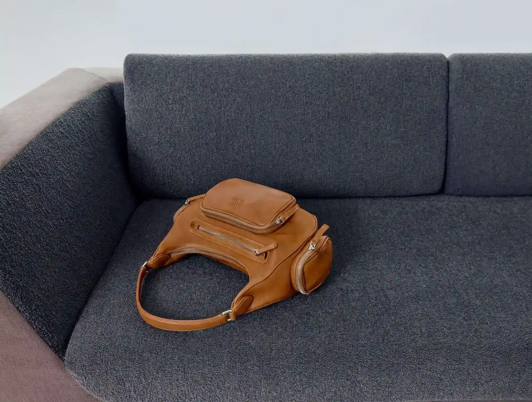 image about Miu Miu's expanded Pocket Bag collection, detailing the various styles, materials, and design features of bags characterized by functional exterior pockets originally introduced in the brand's Spring/Summer 2023 runway show. (image 2 of 2)
