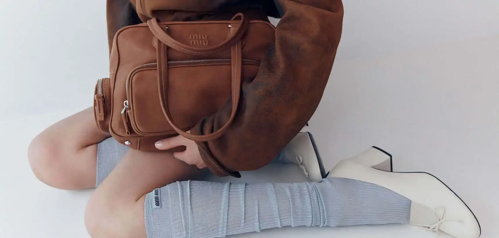 image about Miu Miu's expanded Pocket Bag collection, detailing the various styles, materials, and design features of bags characterized by functional exterior pockets originally introduced in the brand's Spring/Summer 2023 runway show.