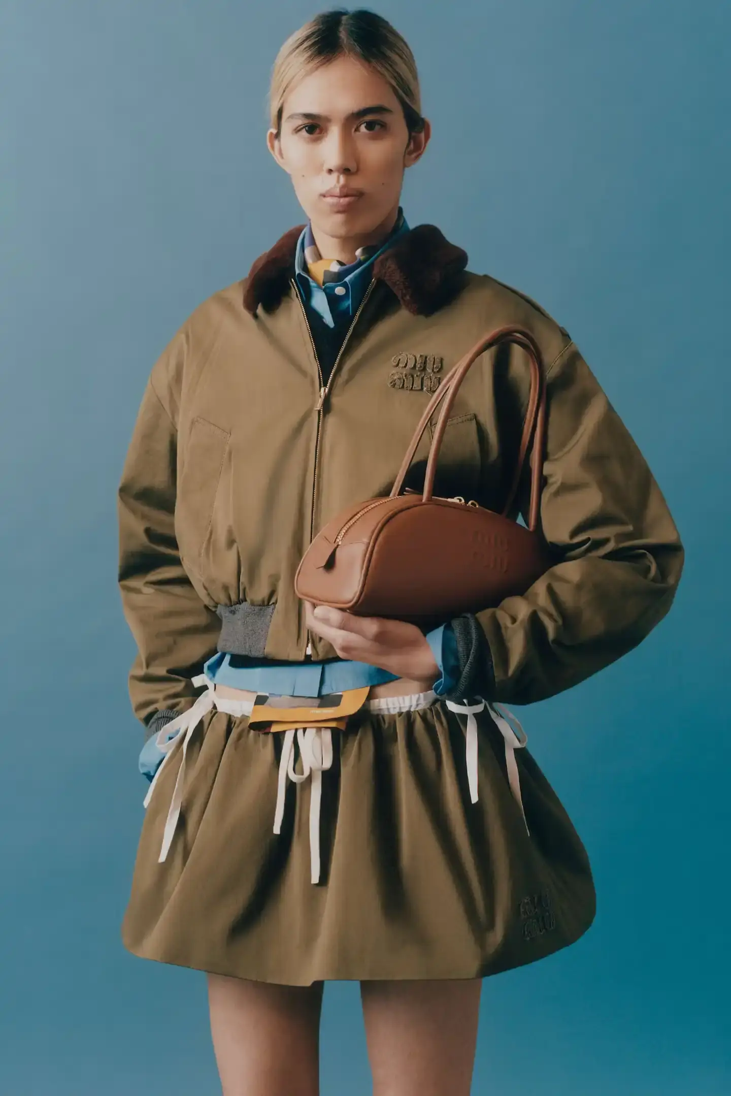 MIU MIU OPENS 2026 WITH PRELUDE COLLECTION Miu Miu introduces Prelude collection for 2026, featuring workwear-inspired pieces, two new sneaker models with customization options, and a range of bags and ready-to-wear items. (image 7 of 11)