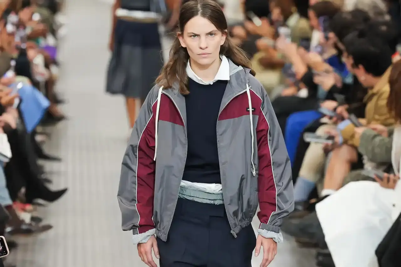Article detailing Miu Miu's Asian pop-up tour schedule for early 2025, featuring the new Gymnasium collection and Custom Studio across five locations. Information includes dates, venues, product details about athletic-inspired bags and sneakers, and customization options available both in-store and online.