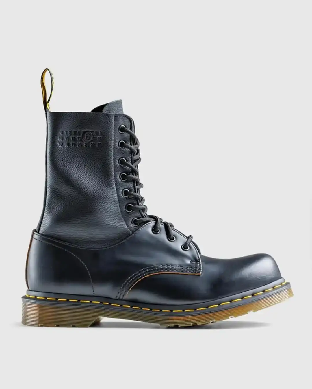 All-black leather boot with elevated profile, merging Dr. Martens 1460 and 1461 designs with visible yellow stitching