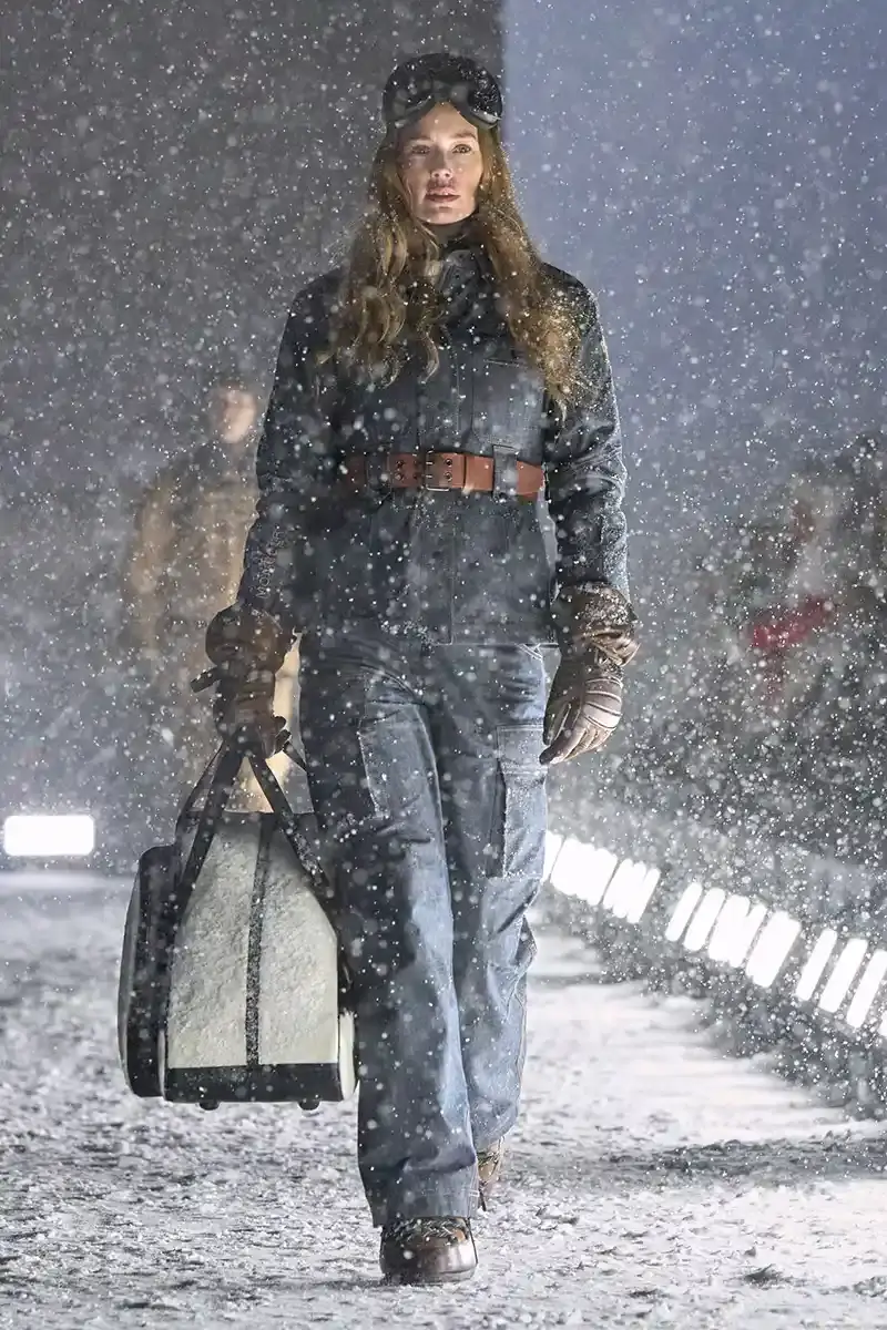 Moncler Moncler's Fall/Winter 2025 Grenoble collection showcase held at Courchevel Altiport in the French Alps. It details how the runway show transformed Europe's highest airport into a fashion venue at 2,008 meters above sea level. The article outlines the collection's 140 looks that blend urban style with mountain functionality, featuring innovative materials like denim and canvas alongside traditional winter textiles. It mentions the craftsmanship details including embroidery and intarsia patterns on ski suits. The article also notes celebrity attendees and a special snowboard collaboration with Shaun White's WHITESPACE brand. The content is organized in paragraphs describing the event setting, collection details, and notable highlights (image 7 of 22)