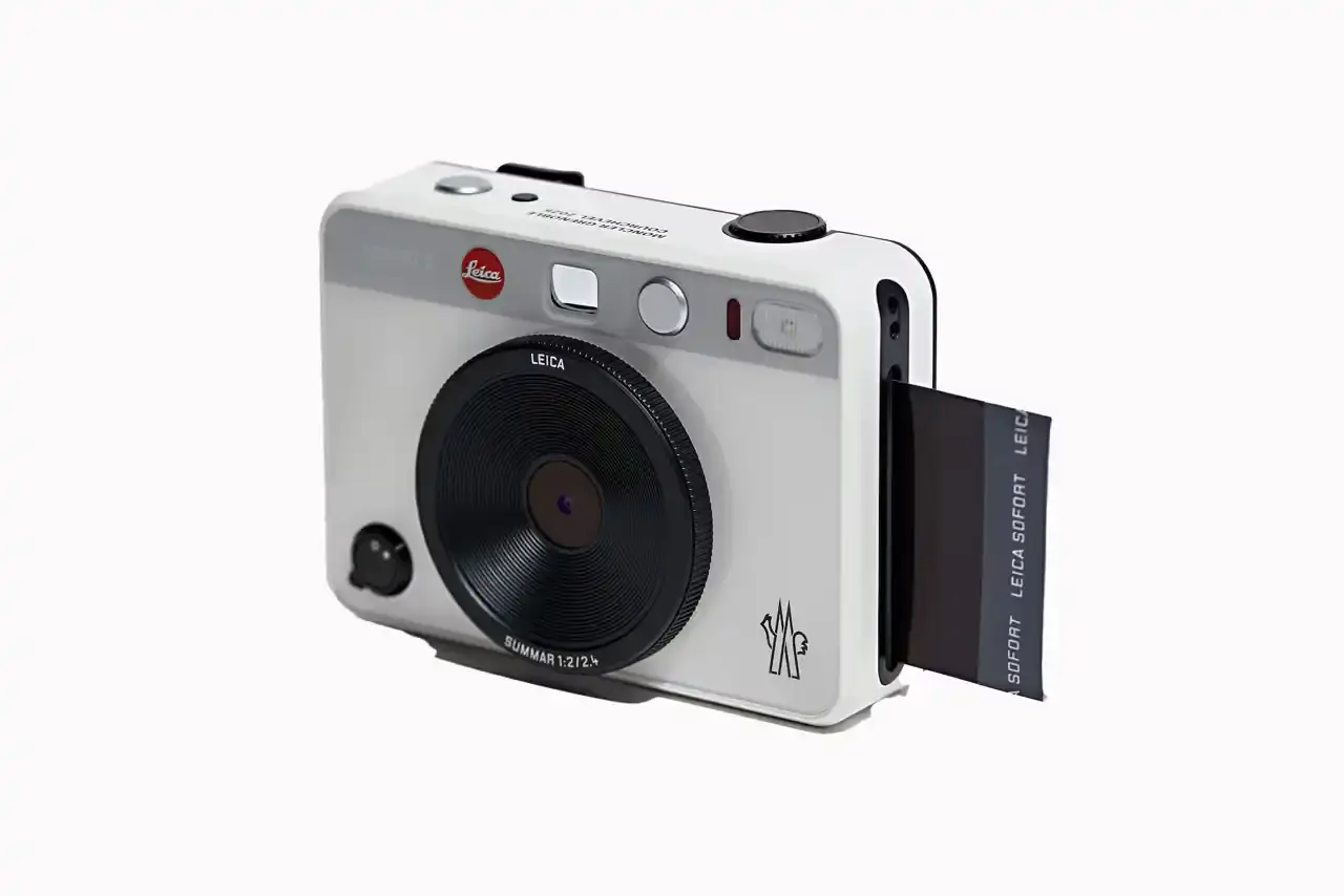 Moncler Limited edition white Leica camera featuring Moncler logo on front and FW25 Courchevel runway inscription on top, created exclusively for Moncler Grenoble's alpine fashion show guests. (image 2 of 3)