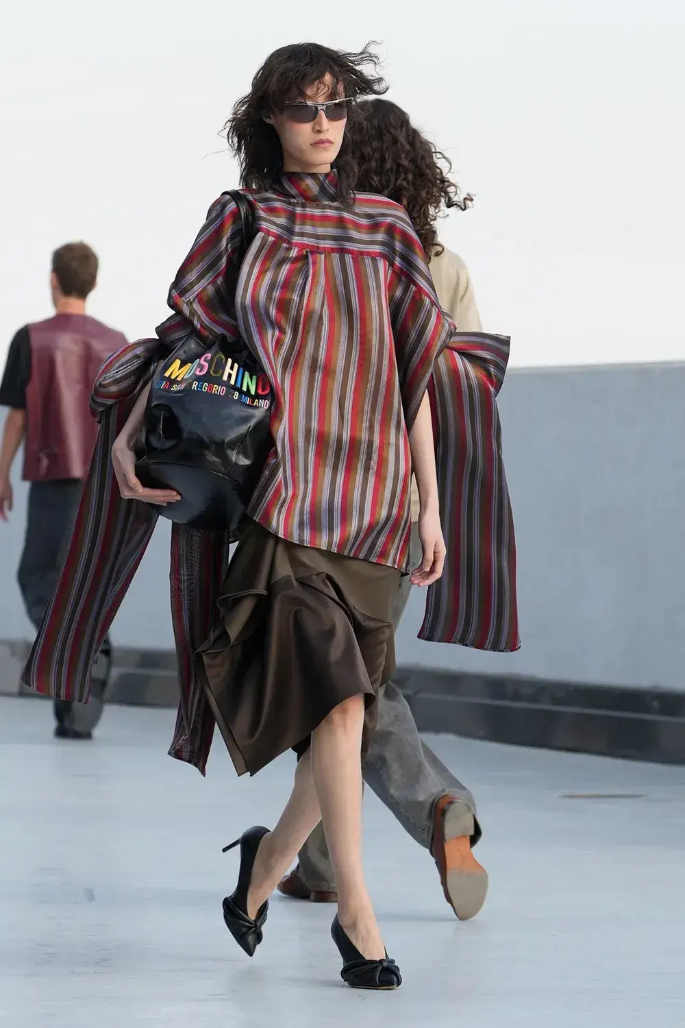 MOSCHINO SS27: MESSINA AND RIZZO DEBUT IN MILAN image of Moschino runway show at Milan Fashion Week, detailing the archival approach of creative director Adrian Appiolaza and brand history under Aeffe Group. (image 7 of 14)