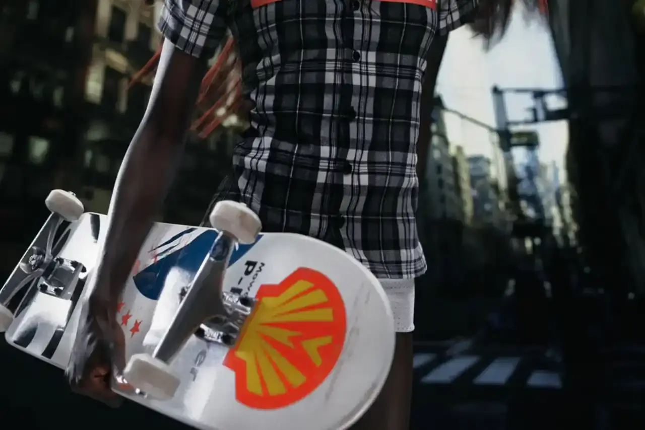 MOWALOLA TEAMS UP WITH THE SKATEROOM FOR DECK COLLECTION image reports on a collaboration between fashion designer Mowalola Ogunlesi and skateboard company THE SKATEROOM. The piece describes a collection of five skateboard decks that incorporate the designer's visual branding elements, including animal prints and logo designs. The article provides details about the construction materials, design features, and availability of the products. It contextualizes this collaboration within Mowalola's broader creative work across fashion, music, and art. The content is structured with a summary section, product descriptions, and background information about the designer's creative ecosystem. (image 8 of 10)