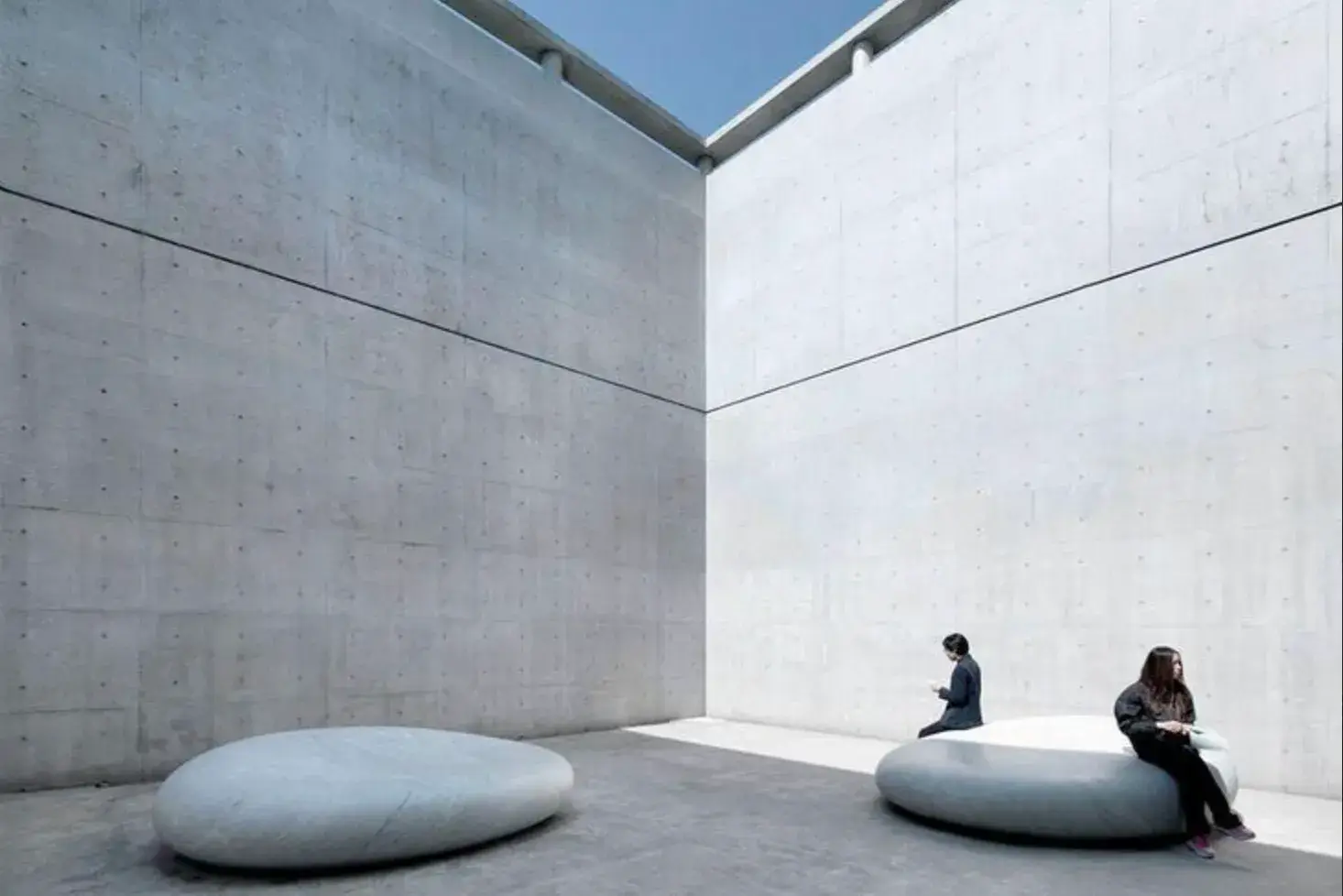 NAOSHIMA: THE ISLAND THAT TURNED DECAY INTO ART Aerial view of the Chichu Art Museum, with geometric skylights emerging from green hills (image 1 of 4)