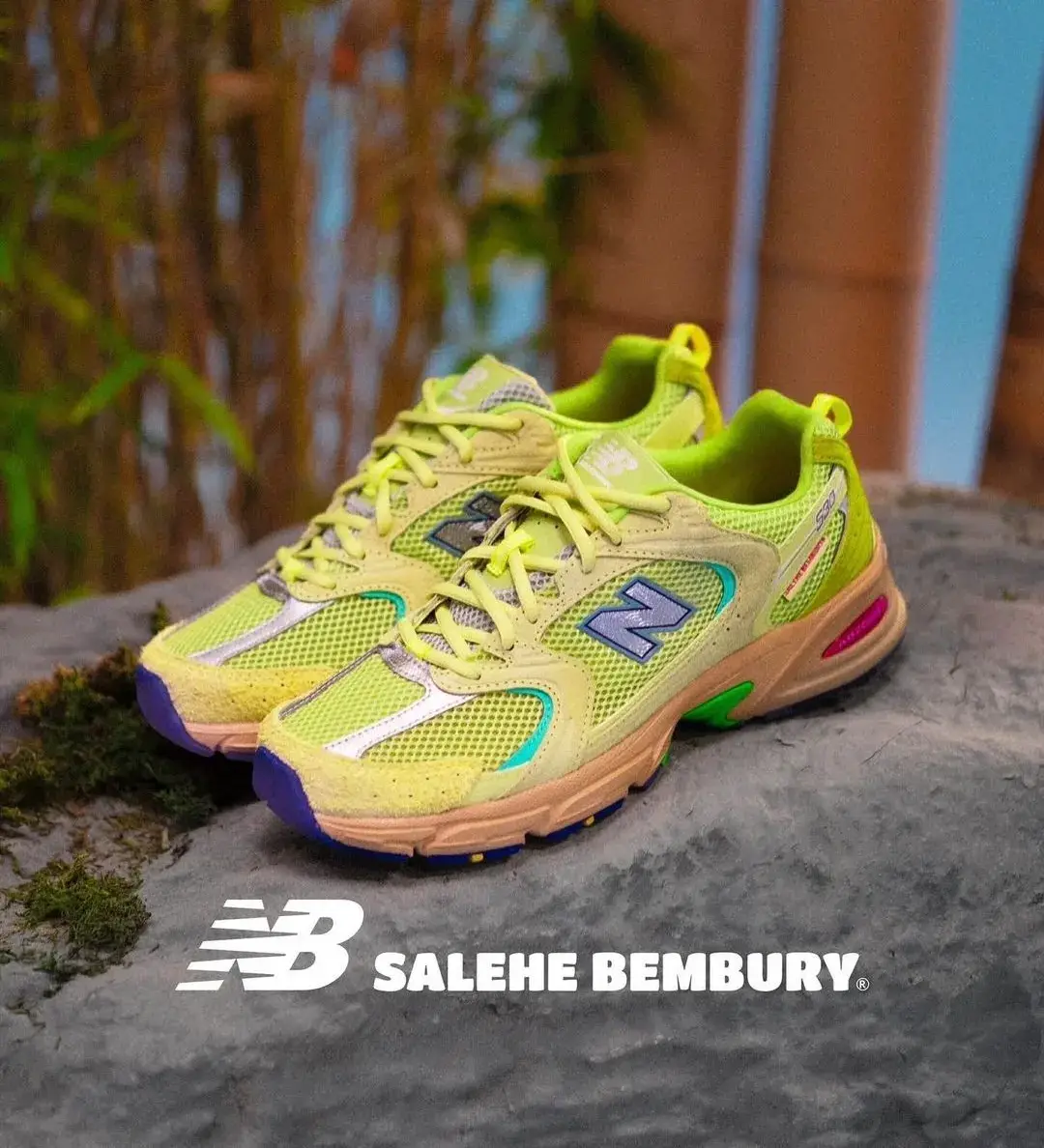 Salehe Bembury x New Balance 530 Bamboo sneaker shown in profile view, featuring yellow mesh upper with blue and silver accents, fingerprint-textured N logo, and salmon pink ABZORB midsole with green details