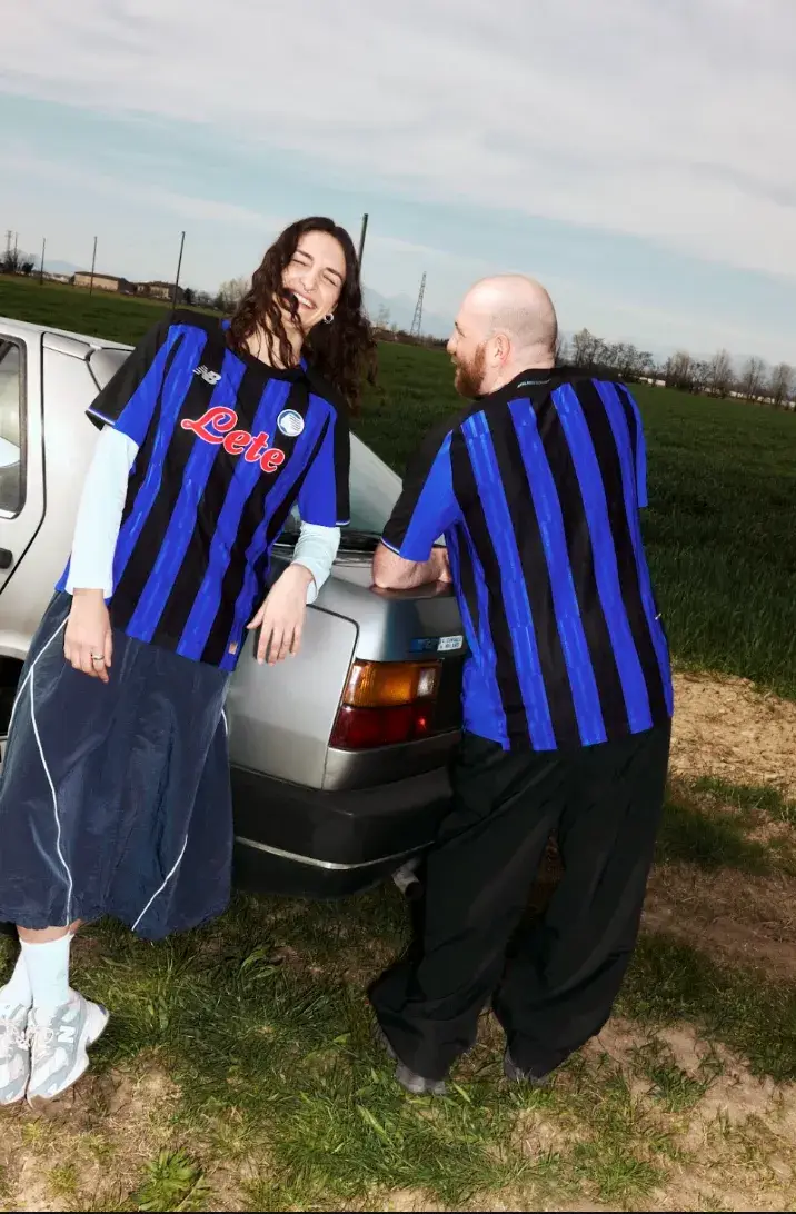 NEW BALANCE REVEALS ATALANTA BC 2026/27 KIT An image of the new Atalanta BC home jersey for the 2026/27 season, featuring Oasis Blue and black vertical stripes with metallic accents. (image 3 of 4)