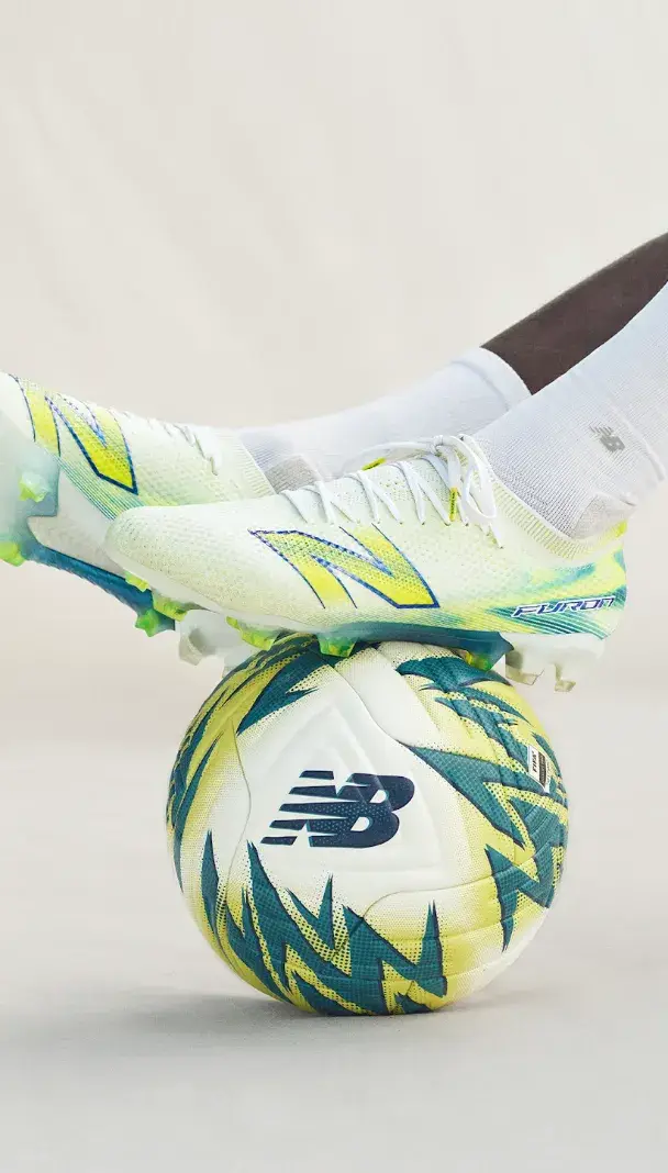 NEW BALANCE LAUNCHES FURON V9 FOOTBALL BOOTS Image of the new alkaline green and metallic blue New Balance Furon v9 football boots showing the soleplate and upper design. (image 3 of 3)