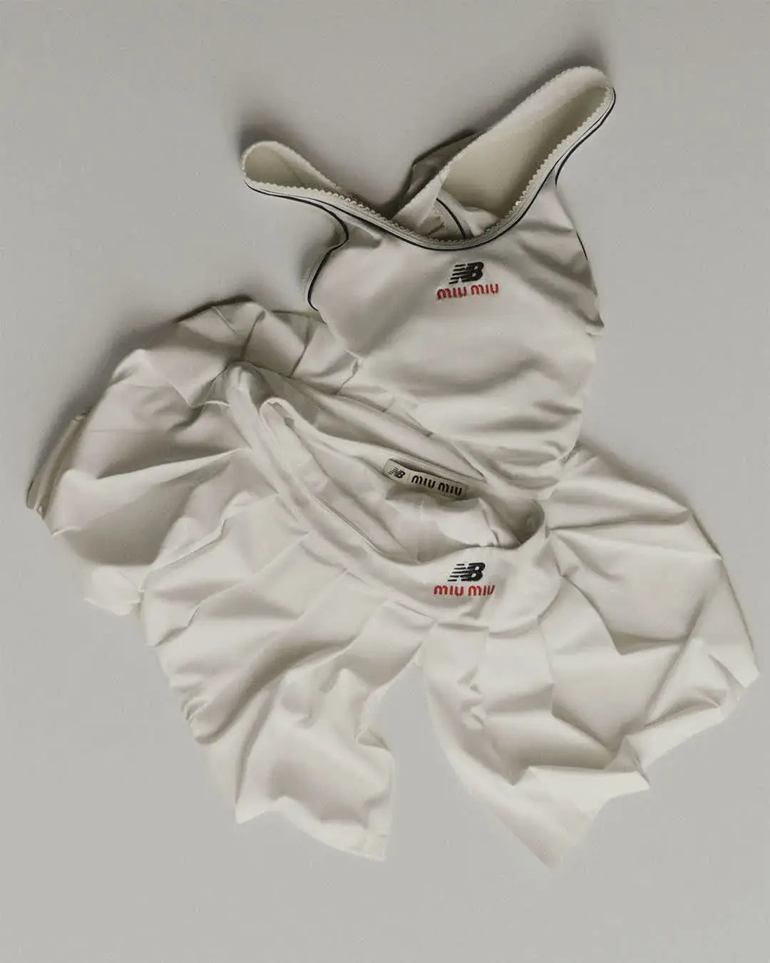 NEW BALANCE AND MIU MIU LAUNCH COCO GAUFF LINE image detailing the performance tennis clothing collaboration between New Balance and Miu Miu worn by athlete Coco Gauff. (image 3 of 12)