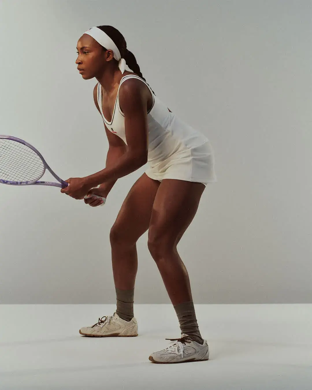 NEW BALANCE AND MIU MIU LAUNCH COCO GAUFF LINE image detailing the performance tennis clothing collaboration between New Balance and Miu Miu worn by athlete Coco Gauff.