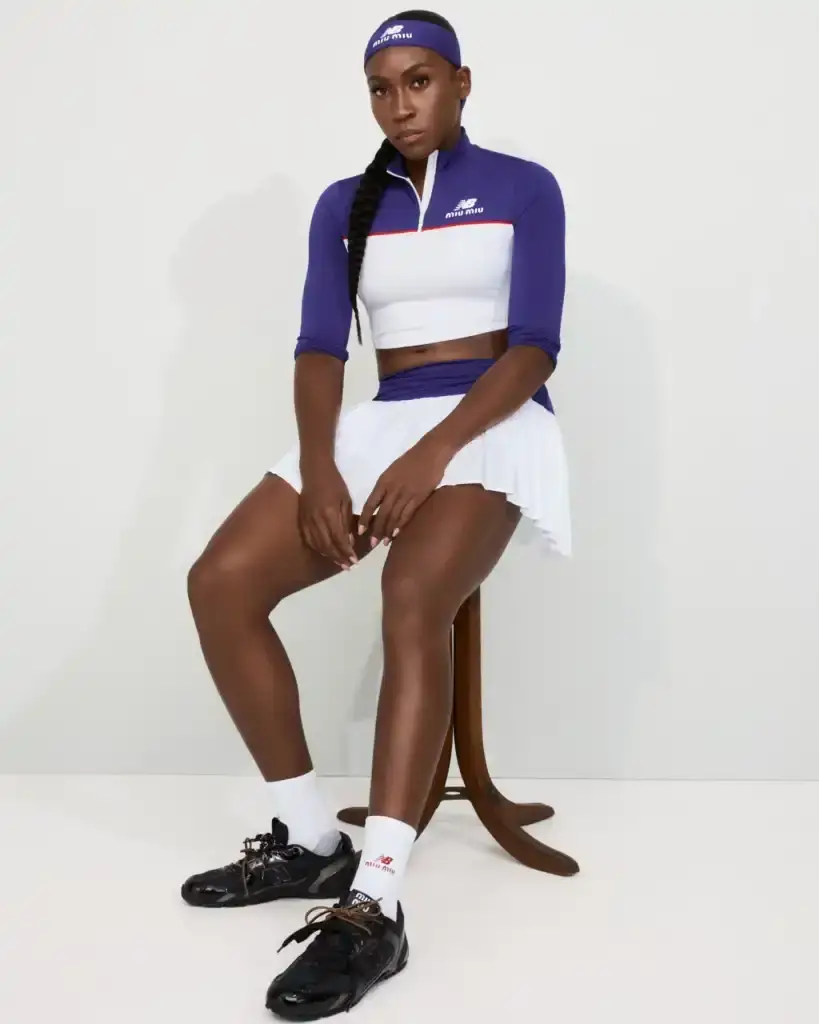 COCO GAUFF TO SPORT NEW BALANCE AND MIU MIU TENNIS COLLECTION image of collaboration between New Balance and Miu Miu featuring tennis champion Coco Gauff. It details how Gauff will wear the collection during tournaments in Rome, Berlin, and Cincinnati, describes the on-court outfits with color-block designs and co-branded Coco CG2 shoes, as well as off-court attire including zip hoodies and 530 SL sneakers. The collection launches September 10th at select stores and online, with Gauff hosting a Miu Miu Select event in New York the same day to showcase her personal picks from the Fall/Winter 2025 collection. (image 6 of 6)