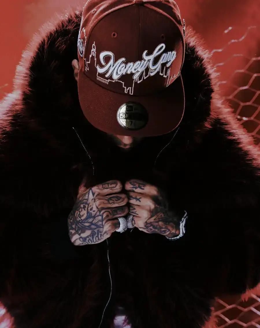 SFERA EBBASTA X NEW ERA HEADWEAR COLLECTION IS HERE image detailing the New Era and Sfera Ebbasta hat collection featuring the Milan skyline and Money Gang logos. (image 2 of 6)