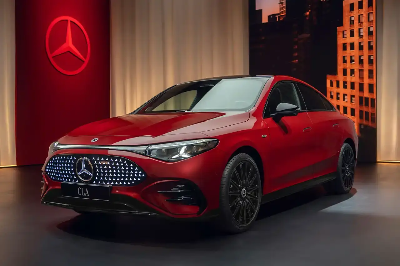 Mercedes-Benz The new Mercedes-Benz CLA sedan featuring a sleek design with illuminated grille, panoramic roof, and minimalist interior with MBUX Superscreen.